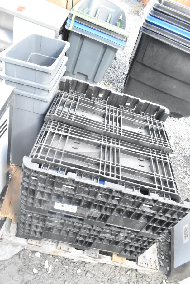 Stack of 5 Orbis black poly bins on pallet, used condition, marked with labels indicating manufacturer and capacity.