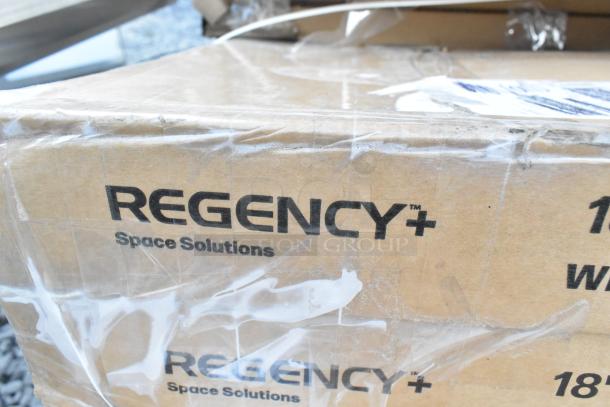 Box labeled "Regency Space Solutions" with visible shipping tape, part of a lot of new scratch and dent items.