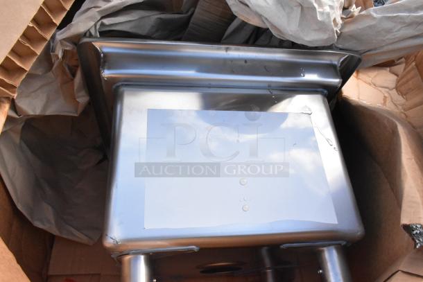 Brand new Regency 30" x 24" stainless steel equipment filler table with backsplash, unboxed, slight dent visible.