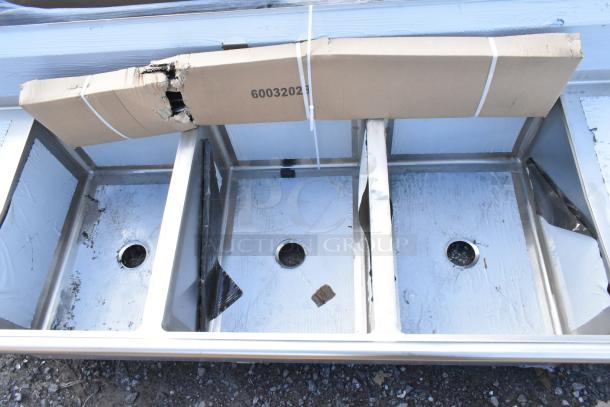 Regency Spec Line 3 bay stainless steel sink with dual drain boards, brand new with packaging damage visible.