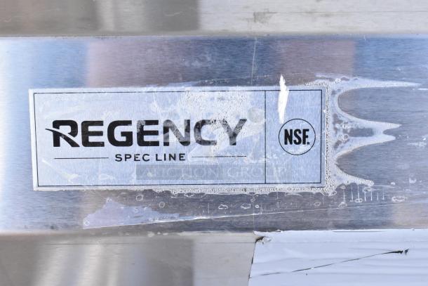 Regency Spec Line stainless steel 3-bay sink with dual drain boards, brand new with scratches. Logo and NSF certification visible.