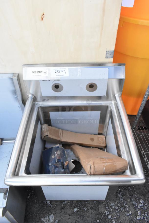 Brand new Regency 600S11818 stainless steel single bay sink, scratch and dent condition, visible labels, unused parts inside.