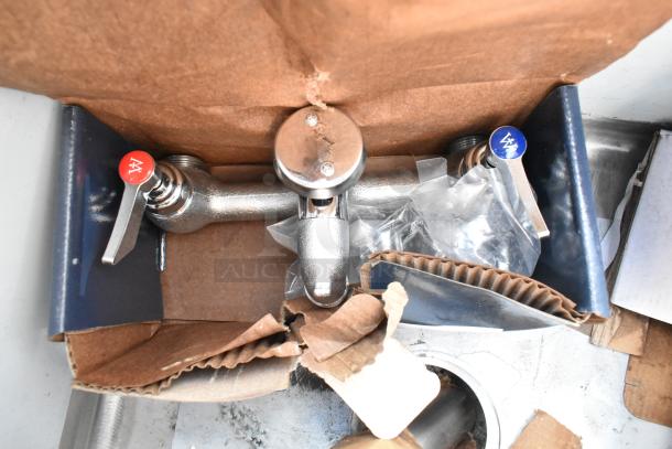 Regency 600S11818 stainless steel sink, brand new with scratch and dent, includes faucet fittings, hot and cold controls.