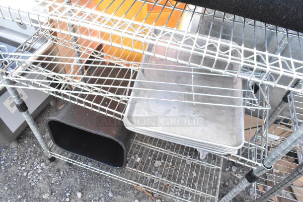 Chrome finish 3-tier wire shelving unit holding various items, including a floor mat, requiring buyer dismantling for shipping.