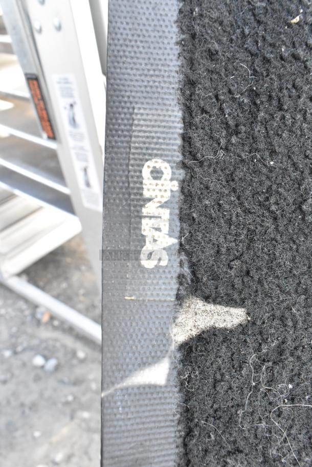 Chrome 3-tier wire shelving unit with contents including a Cintas floor mat. Buyer's dismantling required. Consider freight.