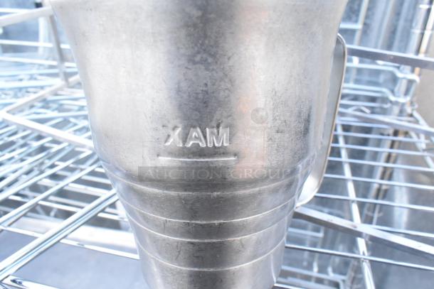 Chrome 3-tier wire shelving with metal baking pans. Marked "XAM". Shelving requires dismantling for shipping.