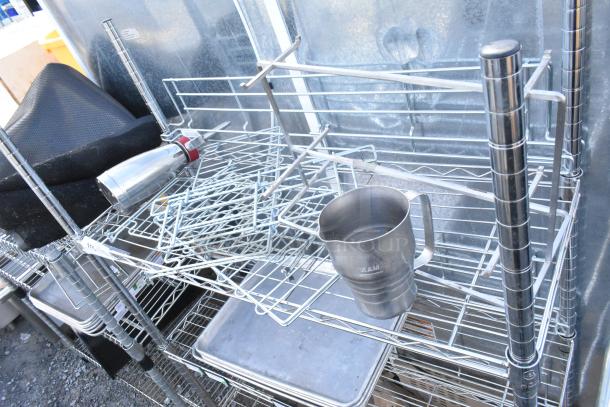 Chrome finish 3-tier wire shelving unit with metal baking pans and miscellaneous items. Buyer must dismantle; freight required.