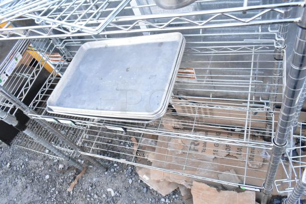 Chrome finish 3-tier wire shelving unit with metal baking pans. Buyer must dismantle. Consider freight charges.