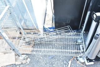 Chrome finish wire shelving unit on casters, single tier, used condition, requires dismantling for shipping.