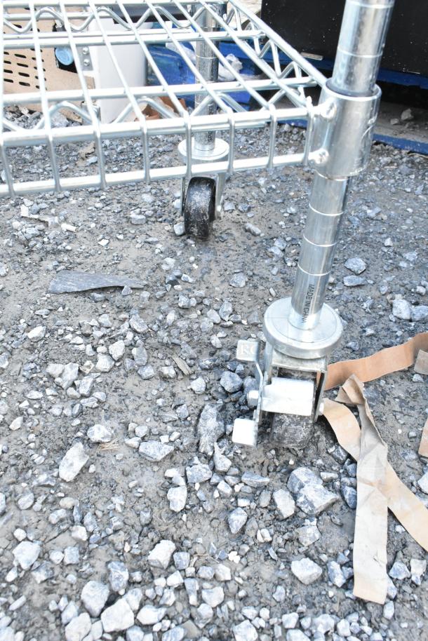 Chrome finish single-tier wire shelving unit on commercial casters, dismantling required, consider freight charges.