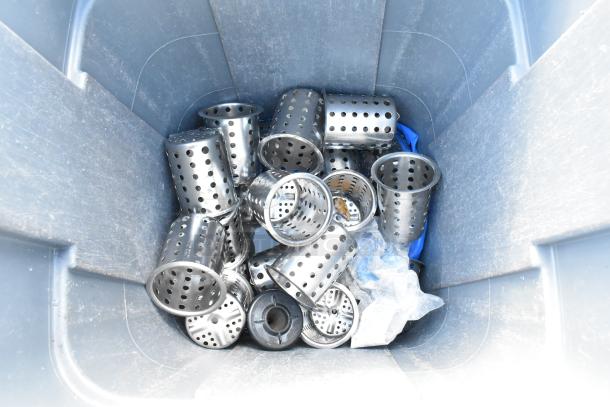 Gray poly trash can with metal silverware bins and trash can dolly inside. Some wear, includes multiple perforated bins.
