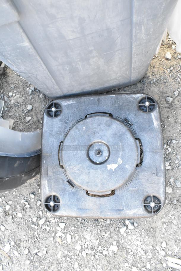 Gray poly trash can with contents, featuring a trash can dolly and metal silverware bins, all in used condition.
