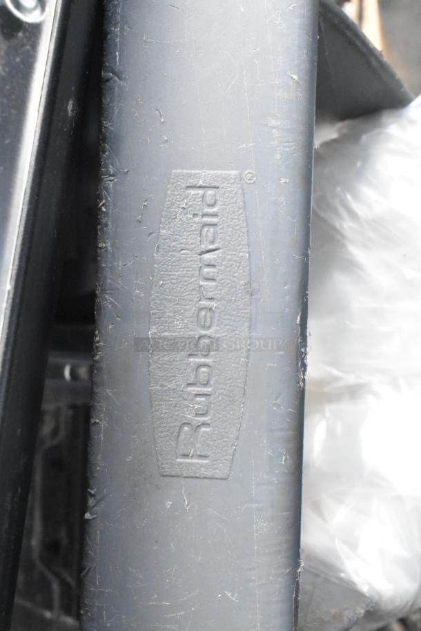 Rubbermaid gray poly trash can, visible logo, includes dolly and metal silverware bins, used condition.