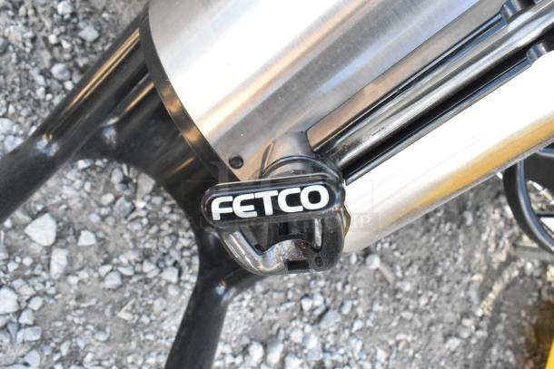 Chrome finish 3-tier wire shelving unit with tanks. Includes FETCO tap handle. Buyer must dismantle for shipping.