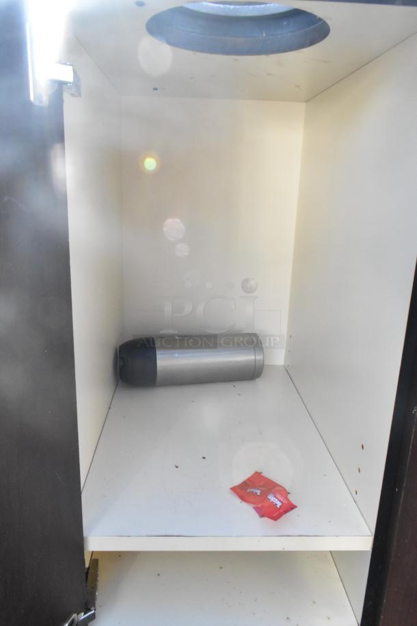 Trash can shell with deposit holes, featuring interior view. Includes doors on commercial casters. Visible wear.