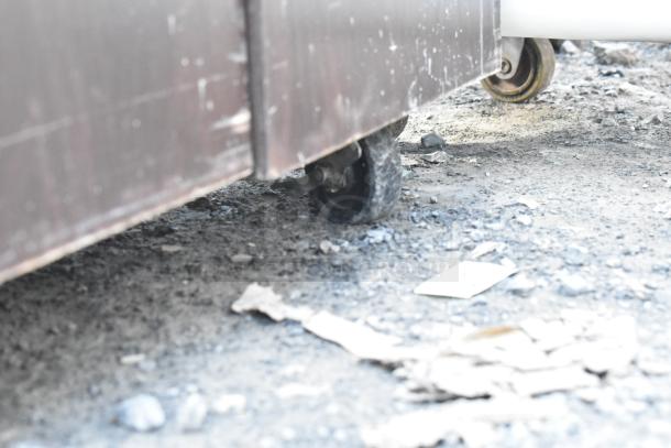 Trash can shell with deposit holes and doors, shown on commercial casters. Condition appears worn.