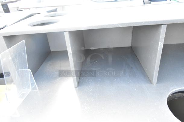 Industrial trash can shell with deposit holes, doors, and commercial casters. Used condition. Sturdy metal construction.