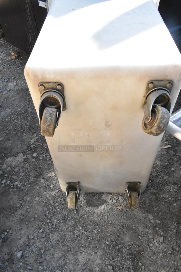 White poly ingredient bin with caster wheels in used condition. Ideal for storage and mobility.