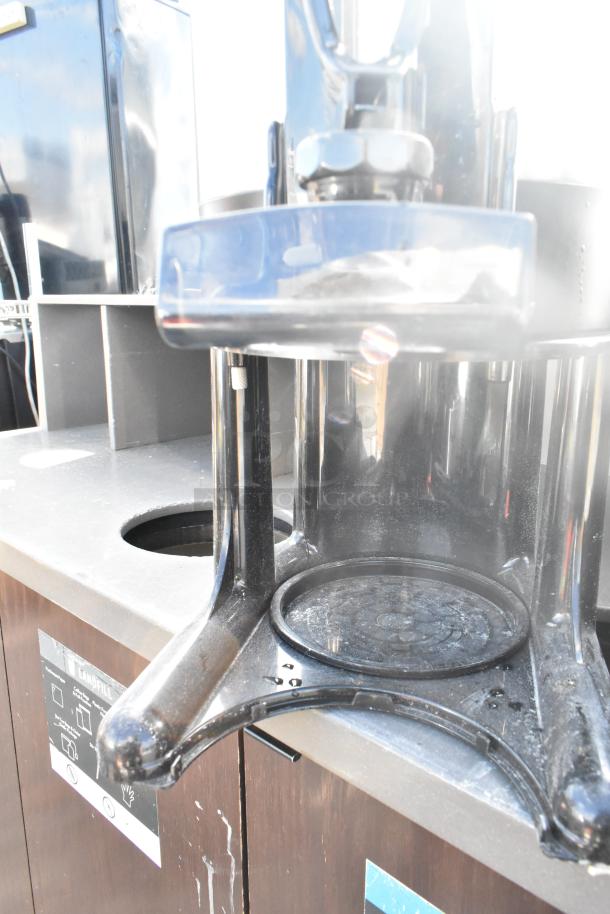 Commercial beverage server satellite on countertop, used condition, part of a lot including white poly ingredient bins.