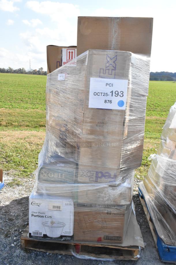 Shrink-wrapped pallet with various boxed items, including towels and portion cups. Boxes marked "Choice Clear Plastic Portion Cup" and FedEx. Brand new, scratch and dent condition.