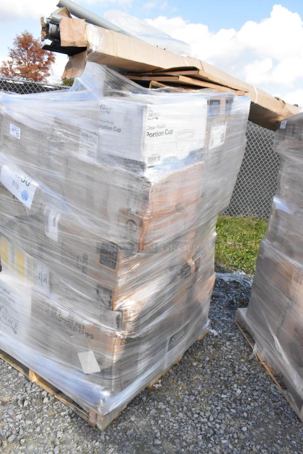 Large pallet of assorted scratch and dent items including napkins, plates, gloves, and cups, shrink-wrapped and labeled.