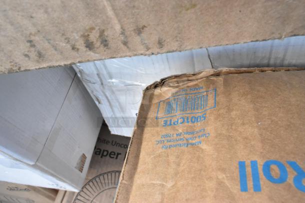 Cardboard boxes labeled "500CTPE," containing assorted new scratch and dent items like containers, towels, and cups.