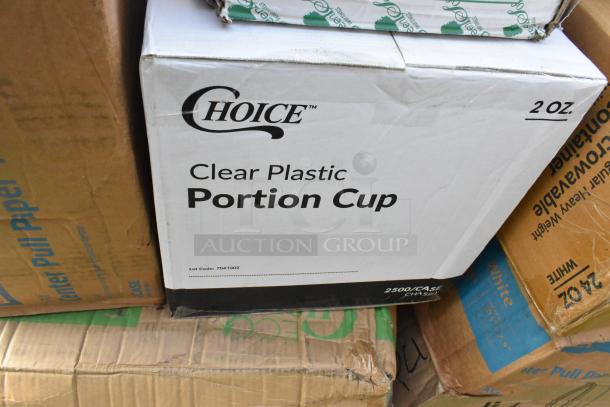 Box labeled "Choice Clear Plastic Portion Cup" marked 2 oz, showing some wear. Part of 27 scratch and dent items auction lot.