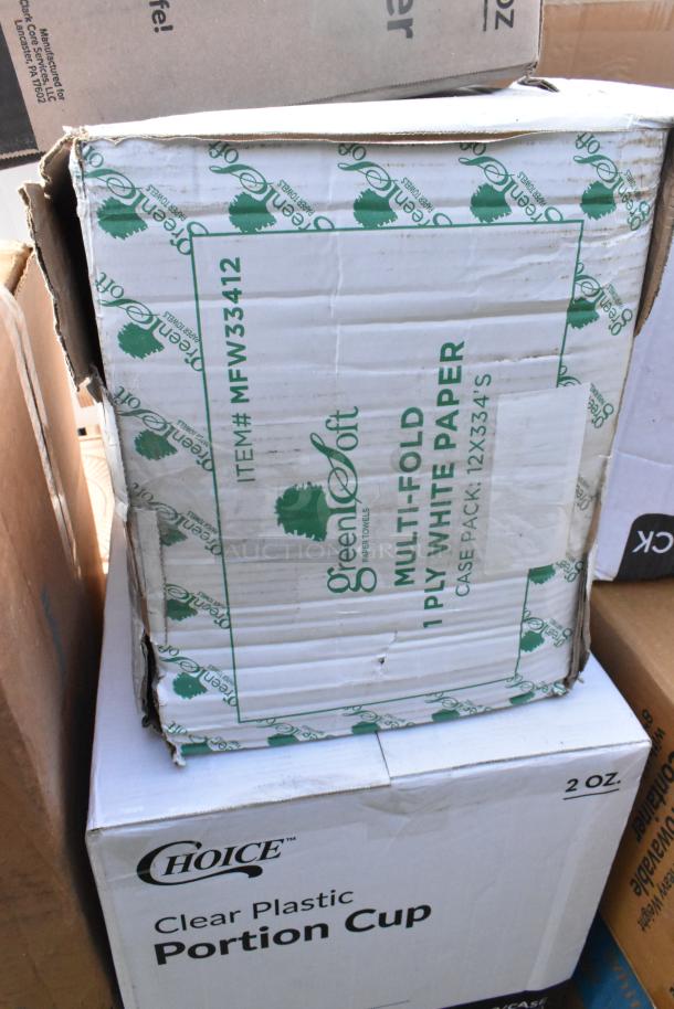 Boxes of Green Soft paper towels and Choice clear plastic portion cups, showing minor packaging wear. Items are new.