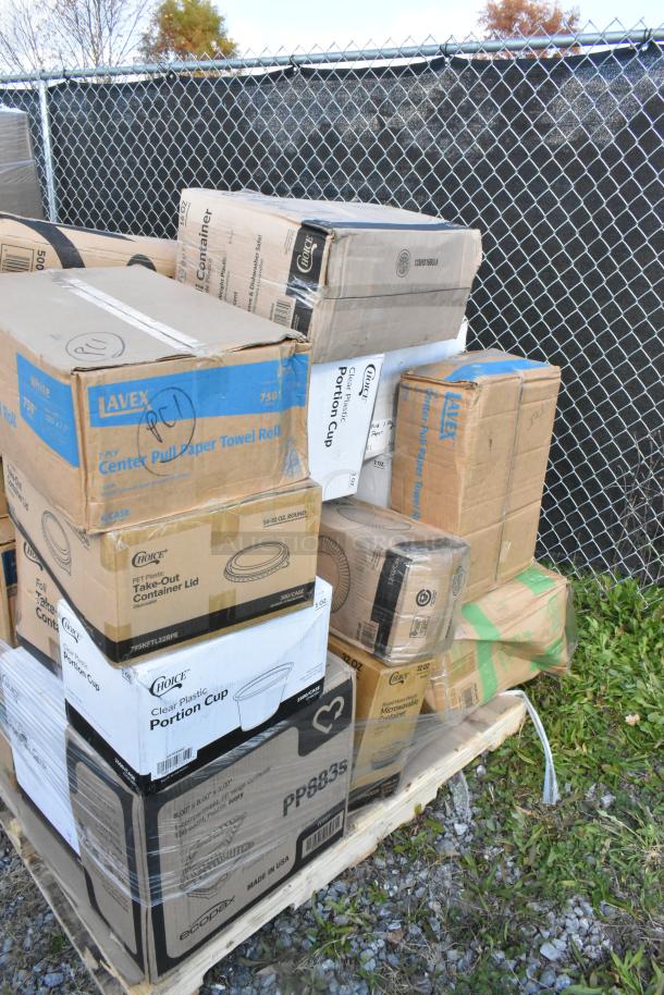 Stack of boxed items on a pallet, labeled Lavex paper towels, Choice container lids, scratch and dent condition.