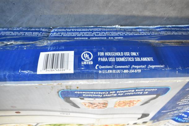 2 Oster F227JN Countertop Heated Food Warmers in original packaging. UL listed for household use, barcode: 034264462267.