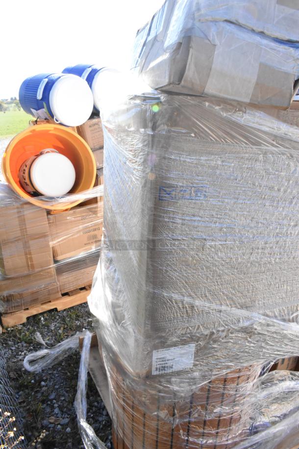 Bulk pallet with various scratch and dent items, including wine glasses and a burger press, wrapped in plastic. Labels visible.