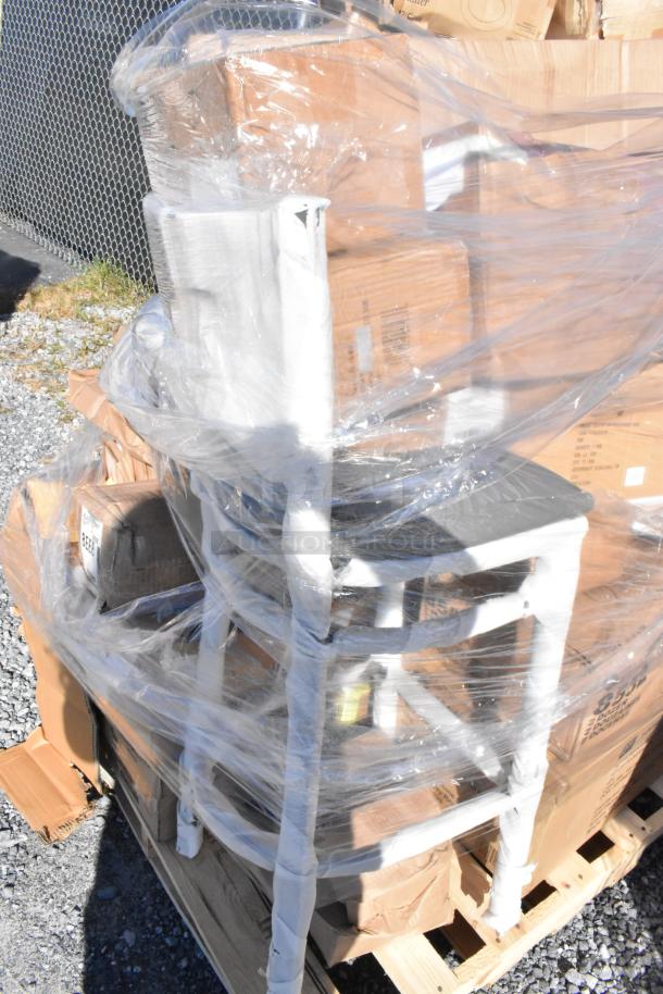 28 brand new scratch and dent items on a pallet, wrapped in plastic. Includes wine glasses and a burger press.