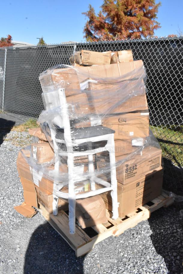 Pallet of 28 new scratch and dent items, including wine glasses and burger press, wrapped in plastic, on gravel.