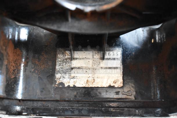 Metal commercial countertop espresso bean grinder with visible wear and rust. Features a label with model number 1635. 115 volts, 1 phase.