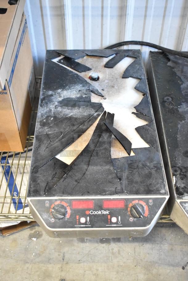 CookTek MC2502F metal commercial induction range with broken glasstop, 200-240 volts, 2 burner, controls visible.