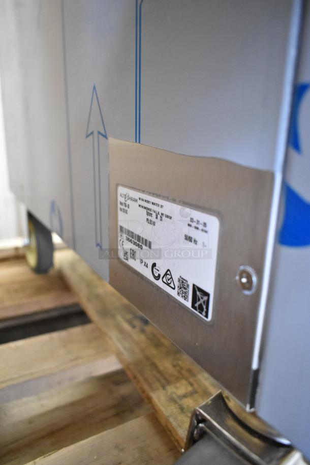 Brand new Alto Shaam 1750-SK stainless steel commercial smoker oven in box; label shows model details and certifications.