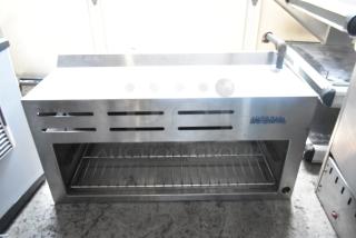 Imperial ICMA-36 stainless steel cheese melter, natural gas powered, commercial use, visible branding, in good condition.