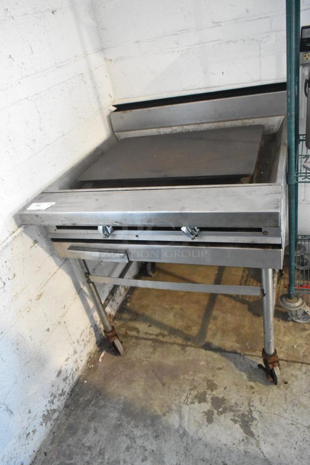 Stainless Steel Commercial Gas Powered Flat Top Griddle on Commercial Casters. - Image 1 of 8