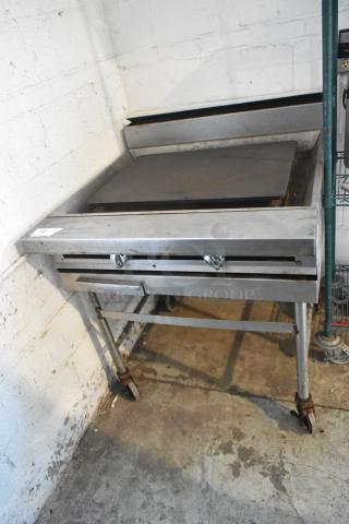 Stainless Steel Commercial Gas Powered Flat Top Griddle on Commercial Casters.