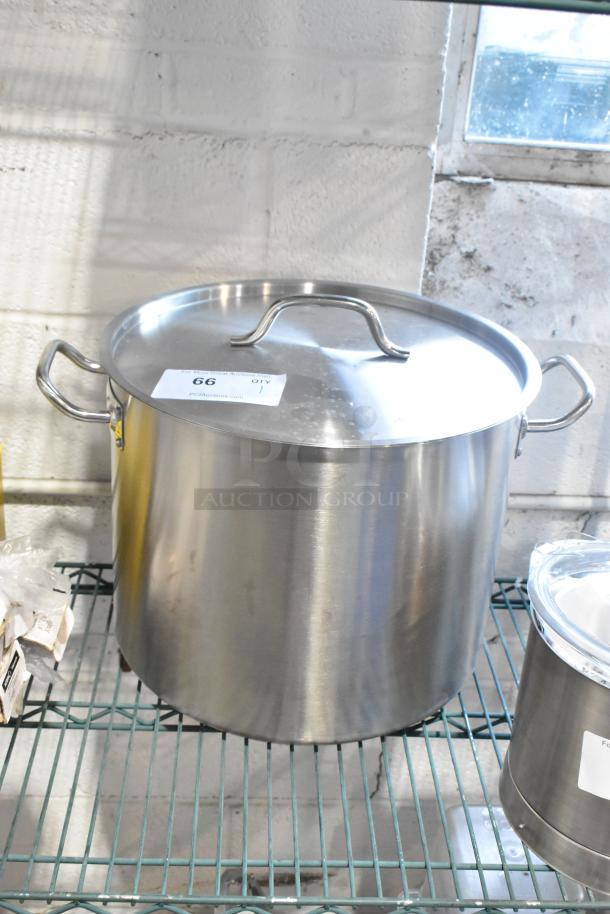 Brand new Vigor 32 Qt. stainless steel, aluminum-clad stock pot with cover, scratch and dent, SS1 Series, visible auction label.