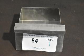 Brand new stainless steel flat top griddle grease tray, visible scratch and dent. Auction label with "84 QTY 1."