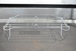 Brand new metal rack with minor scratches and dents. Made of durable metal wire, suitable for storage and organization.