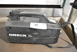 BRAND NEW Scratch and Dent Oreck XL BB880-AD Vacuum Cleaner, 120 Volts, 1 Phase. Visible scuffs, auction tag attached.