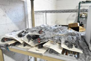 Brand new set of 40 utensils including tongs and cherry pitter, in original packaging, stacked on a shelf.