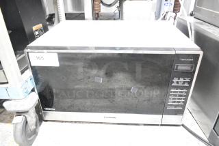 Panasonic metal countertop microwave oven, 120 volts, 1 phase. Door does not open. Model: Genius.