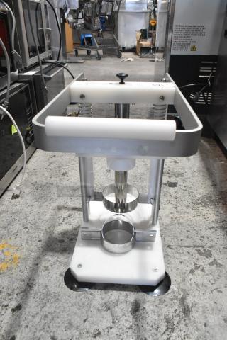 Metal pineapple corer with sturdy stainless steel construction, spring mechanism, and handle. Ideal for efficient coring.