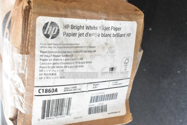 Brown box of HP Bright White Inkjet Paper, 24in x 150ft, model C1860A, with visible barcode and various languages on the label.