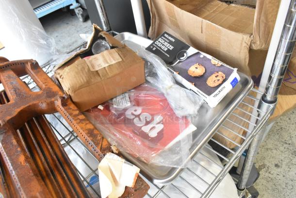 Auction lot with HP Bright White Inkjet Paper, Vollrath squeeze disher, UPR6GE plates, metal pieces, and various items on a metal rack.