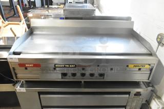 MagiKitch'n stainless steel commercial griddle, gas-powered, with thermostatic controls. Features labels for meat and poultry.