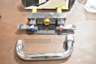 Chrome metal faucet with dual handles, labeled for hot and cold. Includes connecting pipe, new condition, suitable for bathroom or kitchen.